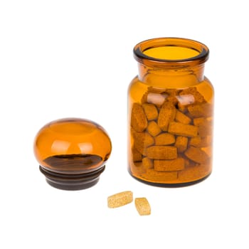 Full vintage apothecary bottle with pills and open lid and spilled pills isolated on white background