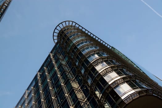 London, United Kingdom - October 10, 2006: Glass and steel offices ("4 More London Riverside"" designed by Foster and Partners), view to top, with clear sky above. Example of modern architecture in UK"