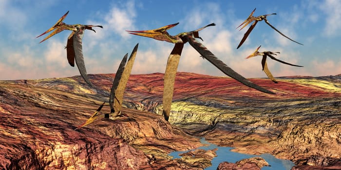Pteranodons reptiles fly over a mountainous landscape in the Cretaceous Period of North America.
