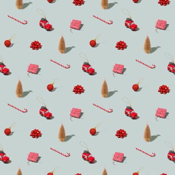 Gray green background pattern with Christmas, New Year symbol attribute objects and symbolic items concept. Small red taxi car toy, pink gift box present, lolli pop candy, lollypop, ball, fir tree