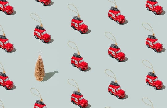Gray green background pattern with Christmas or New Year symbol attribute objects and symbolic items concept. Small red English taxi car toy with ribbon, golden little toy fir tree. High quality photo