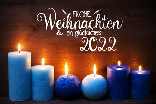 German Calligraphy Frohe Weihnachten Und Ein Glueckliches 2020 Mean Merry Christmas And Happy 2020. Turquoise Romantic Candle Light With Brown Wooden Background
