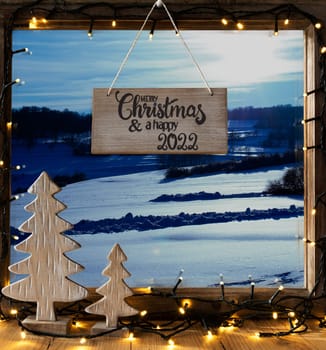 Window With Sign With English Calligraphy Merry Christmas And A Happy 2022. View Till Winter Scenery, Christmas Decoration Like Tree