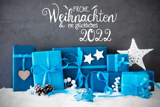 German Calligraphy Frohe Weihnachten Und Ein Glueckliches 2022 Means Merry Christmas And A Happy 2022. Turquoise Gift With Bow And Christmas Decoration. Black Background With Snow
