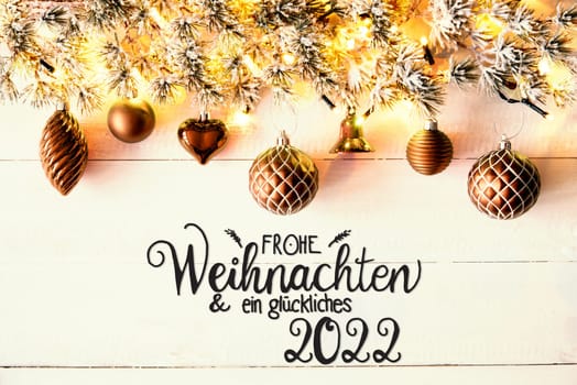 Golden Christmas Decoration With German Calligraphy Frohe Weihnachten Und Ein Glueckliches 2022 Mean Merry Christmas And A Happy 2022. Fir Tree Branch With Shiny Fairy Lights