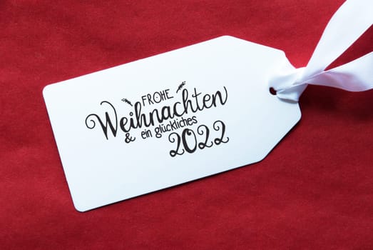 Label With German Calligraphy Frohe Weihnachten Und Ein Glueckliches 2022 Means Merry Christmas And A Happy 2022. Red Textured Background