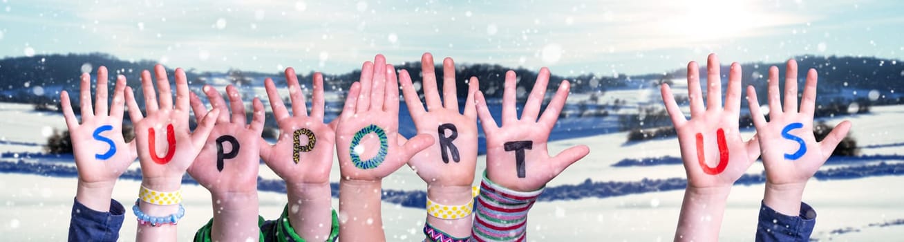 Children Hands Building Colorful English Word Support Us. Snowy Winter Background With Snowflakes