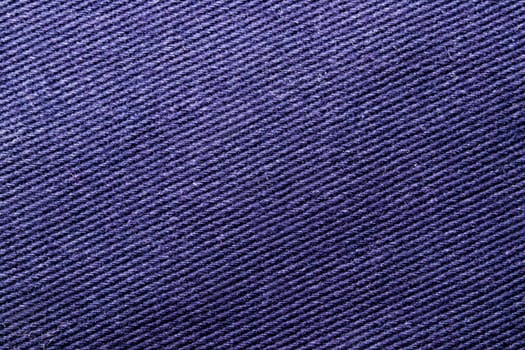 Violet fabric texture. Close-up of a purple seamless pattern for textile, bags or other garments. Macro.