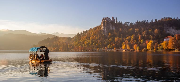 Traditional wooden boat on picture perfect picturesque lake Bled, Slovenia at sunset.
