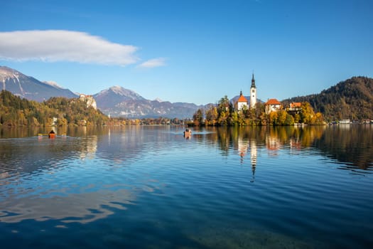 Panoramic view of Julian Alps, Lake Bled with St. Marys Church of the Assumption on the small island. Bled, Slovenia, Europe