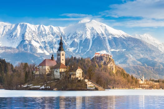 Panoramic view of Julian Alps, Lake Bled with St. Marys Church of the Assumption on the small island. Bled, Slovenia, Europe.