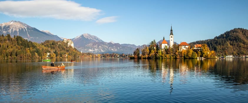 Panoramic view of Julian Alps, Lake Bled with St. Marys Church of the Assumption on the small island. Bled, Slovenia, Europe