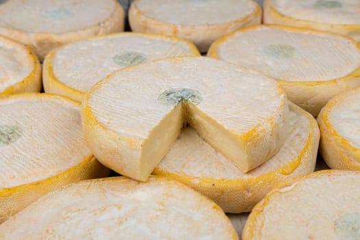 tasted and original mountain cheese named Reblochon as a background