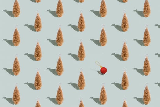Gray green background pattern with Christmas or New Year symbol attribute objects and symbolic items concept. Golden little toy fir tree with shadow, red toy ball or sphere. Book cover, covering paper