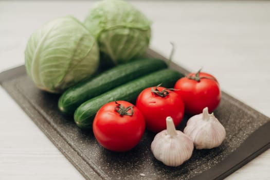 Fresh and Bright Vegetables Lie on the Kitchen Table.