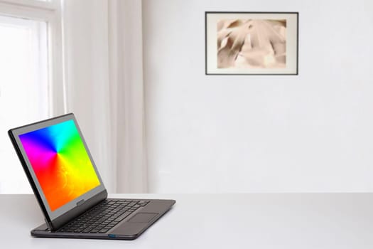 Table top on computer background. Modern portable Laptop with abstract blurred screen on white table over abstract blurred home office background with copy space for text phrases and product montage.