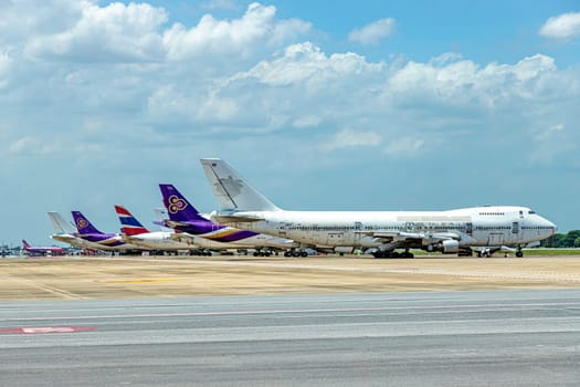 Bangkok, Thailand June 14th, 2018 Don Mueang International Airport (DMK) apron There are planes of Thai Airways parked lined up. There was an unpainted plane parked at the very front in sunny day.