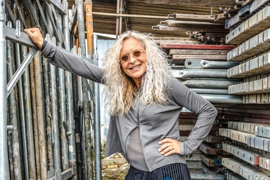 Stylish Lady with long curly hair surround industry area.