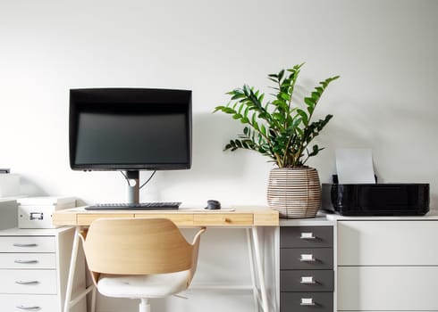 Illustrated view of the modern workplace in white room. Mockup of the workspace with wooden table and computer on it, with plant and printer on the shelve.