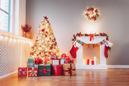 Christmas tree with gift boxes under it in the empty living room. Apartment in new year's eve with decorative fireplace and beautiful fir.