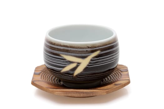 closeup view of ceramic cup for tea on white background