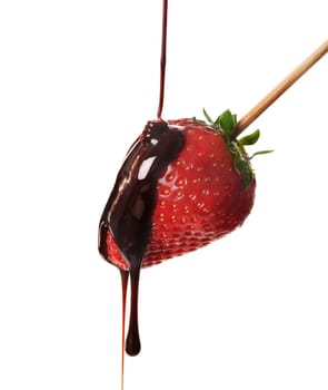 Pouring chocolate over fresh yummy strawberry