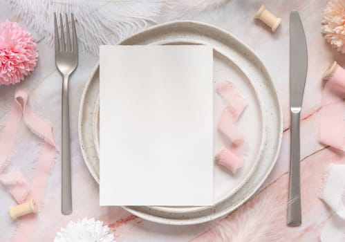 Wedding Table place with a blank card near flowers, silk ribbons and feathers, top view. Romantic template with vertical paper card on a plate on a marble table flat lay. Card mockup, copy space
