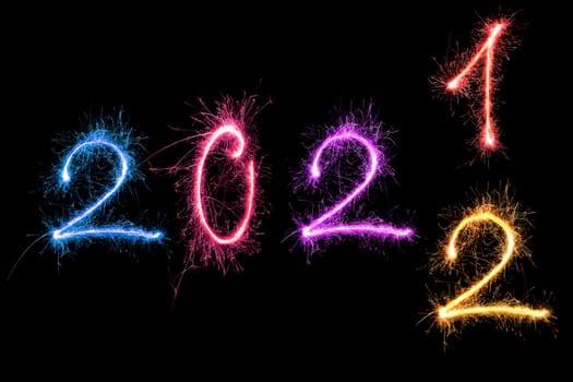 Happy new year greeting. Digits 2022 made from fireworks isolated on black background.