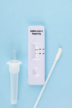 Positive covid 19 test on blue backround. Corona nasal swab test.