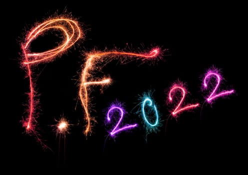 New year greeting card. P.f. pour feliciter 2022 made from sparkling colorful lights isolated on black background. Happy new year.