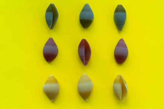 Green, yellow and red paste on a yellow background, top view