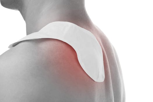 Handsome man with heat patch on shoulder. Shoulder and chronic back pain.