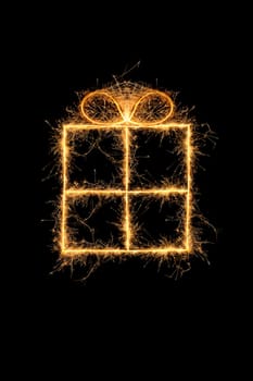 Sparkling gift on black background. Merry chritstmas greeting card.