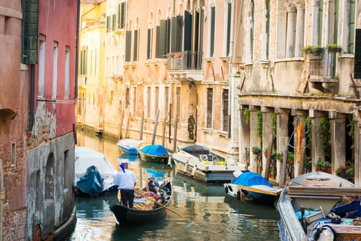 Gondolier on a canal in Venice