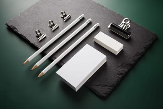 Photo of blank stationery set on stone board. Responsive design template.