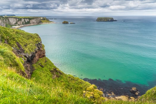 Coastline with tall limestone cliffs, Sheep Island and turquoise Atlantic Ocean, near Carrick a Rede rope bridge, Wild Atlantic Way, Northern Ireland