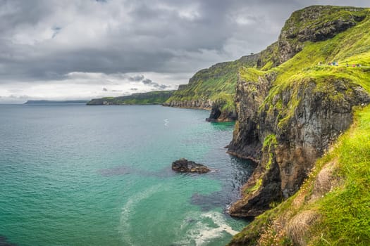 Coastline with tall limestone cliffs, Rathlin Island and turquoise Atlantic Ocean near Carrick a Rede rope bridge, Wild Atlantic Way, Northern Ireland