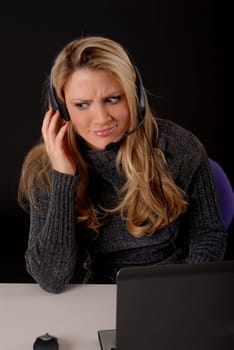 Lovely blond business woman working at laptop computer