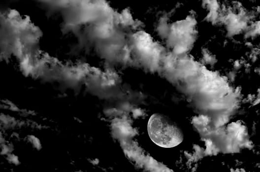 Monochrome image of moon and clouds at night