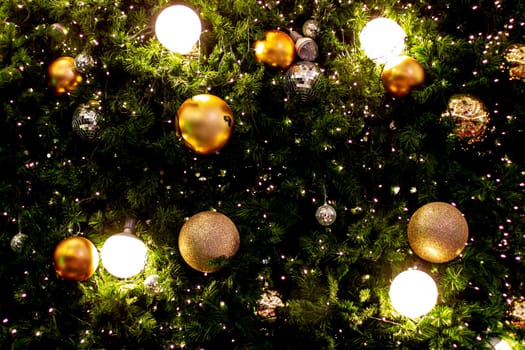 Christmas tree garland and ornaments. Hanging gold and red balls and ribbons. Christmas background. Happy New Year. Selective focus Holiday