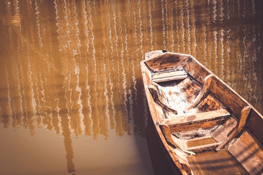 Lonely old wooden boat on the lake suburban traditional culture lifestyle