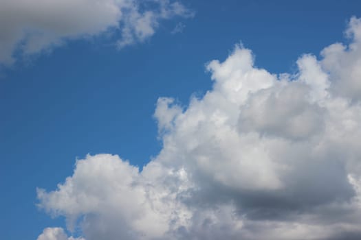 Blue sky background with clouds. white fluffy clouds on blue sky in summer