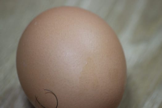Closeup selective view of fresh farm chicken eggs isolated on a wooden background