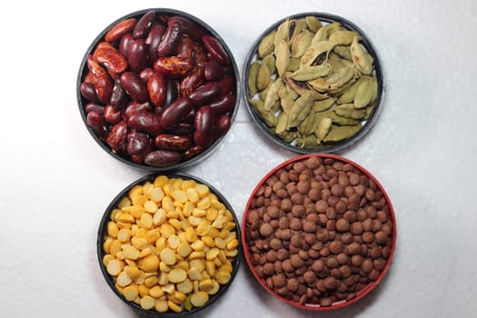 Top view of assortment of cereals, and cardamom. Collection of different spices and cereals.