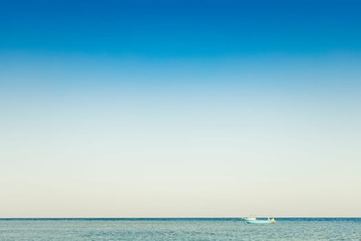 Vessel, yacht photography. Alone blue white boat, ship in silent sea or ocean water surface. A quiet and peaceful harbor bay. Waves tranquil mood. Transportation business. Relax time photo