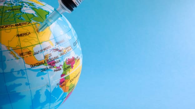 Ukraine, Kiev - April 15, 2020. Globe from the side of America full of syringes. To illustrate the need for a vaccine to fight the global pandemic in the United States caused by the Covid-19 virus