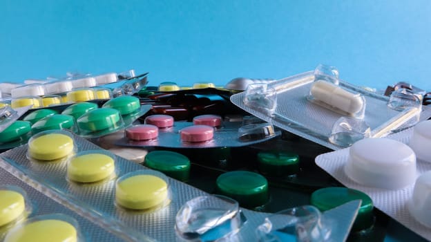 Pills, capsules with medicine, vitamins in the package, in blister packs are on the table. antibiotics, multicolor antibacterial drugs. Healthcare and medicine concept. Copy space