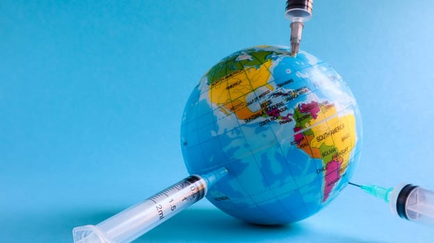 Ukraine, Kiev - April 15, 2020. Globe from the side of America full of syringes. To illustrate the need for a vaccine to fight the global pandemic in the United States caused by the Covid-19 virus