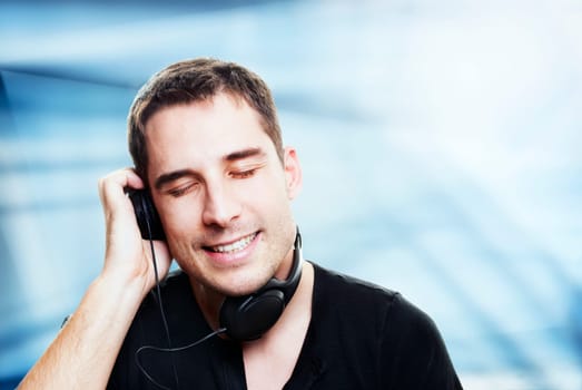 man listening the music in front of abstract background