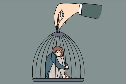 Captivity slavery and freedom concept. Young sad depressed woman sitting in cage which is held by huge human hand manipulating it vector illustration